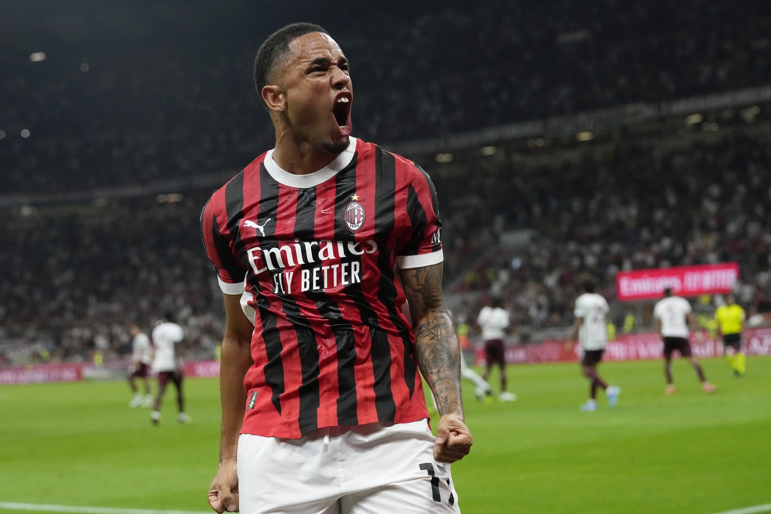AC Milan&#039;s Noah Okafor celebrates after scoring his side&#039;s second goal during the Serie A soccer match between AC Milan and Torino at the San Siro stadium, in Milan, Italy, Saturday, Aug. 17 ...