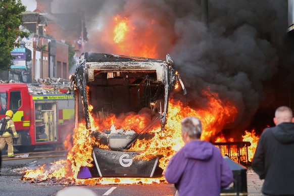 People watch as firemen arrive to put out vehicle that was set alight during a protest in East Belfast following a stabbing incident in Belfast, Tuesday, June 9, 2026. (AP Photo/Peter Morrison)
Britai ...
