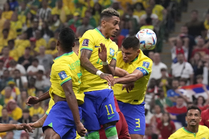 Brazil's Alex Sandro, left, Brazil's Raphinha , centre, and Brazil's Thiago Silva in action during the World Cup group G soccer match between Brazil and Serbia, at the Lusail Stadium in Lusail, Qatar, ...