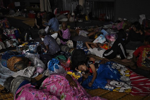 Evacuees take shelter in a gymnasium on the grounds of Surindra Rajabhat University, in the Thai border province of Surin on July 24, 2025. Thailand and Cambodia fought their bloodiest military clashe ...