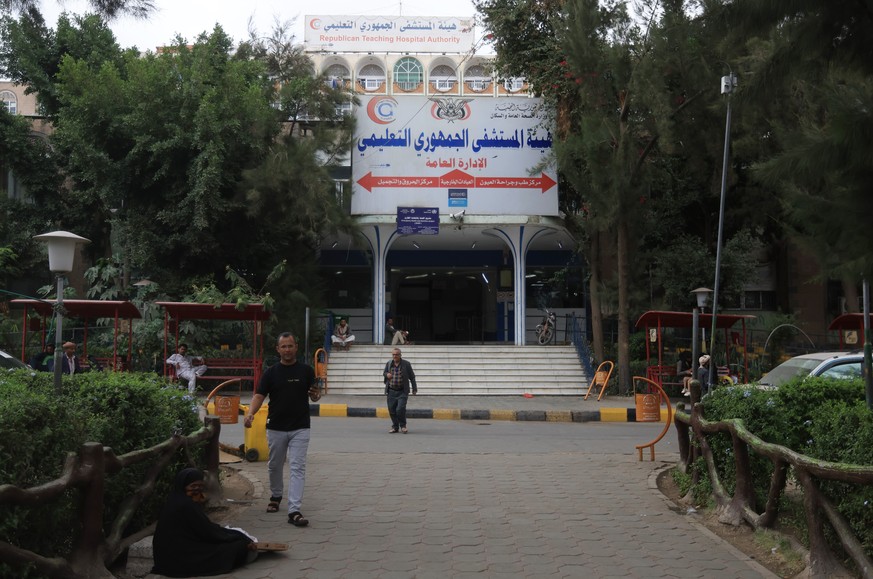 epa12083998 People walk past Al-Jumhuri hospital where people injured in US airstrikes are receiving treatment, in Sana'a, Yemen, 08 May 2025. Yemen's Houthis and the United States have agre ...