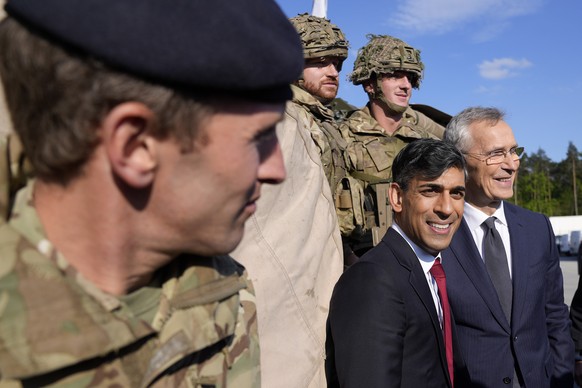 NATO Secretary General Jens Stoltenberg, right, and Britain&#039;s Prime Minister Rishi Sunak for a photo with British soldiers at the Warsaw Armoured Brigade in Warsaw, Poland, Tuesday, April 23, 202 ...