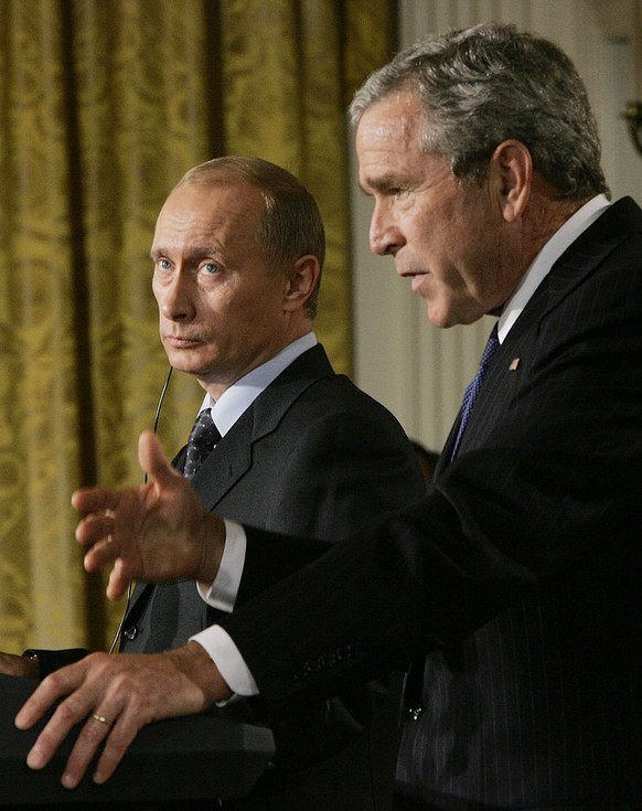 WASHINGTON - SEPTEMBER 16: U.S. President George W. Bush (R) and Russian President Vladimir Putin (L) hold a press conference in the East Room of the White House September 16, 2005 in Washington, DC.  ...