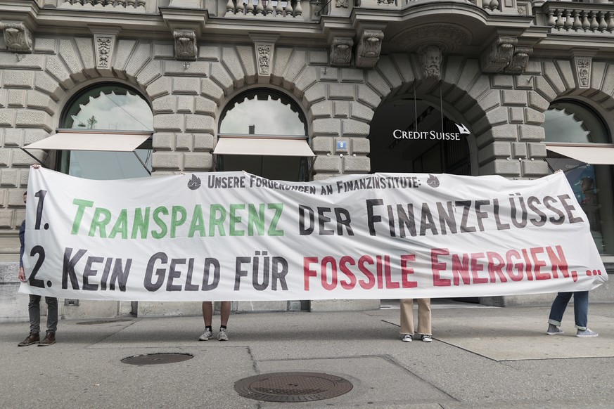Aktivistinnen und Aktivisten von "Rise Up For Change" stehen mit einem Transparent vor der Grossbank Credit Suisse (CS), aufgenommen am Montag, 26. Juli 2021 in Zuerich. Klimaaktivisten habe ...