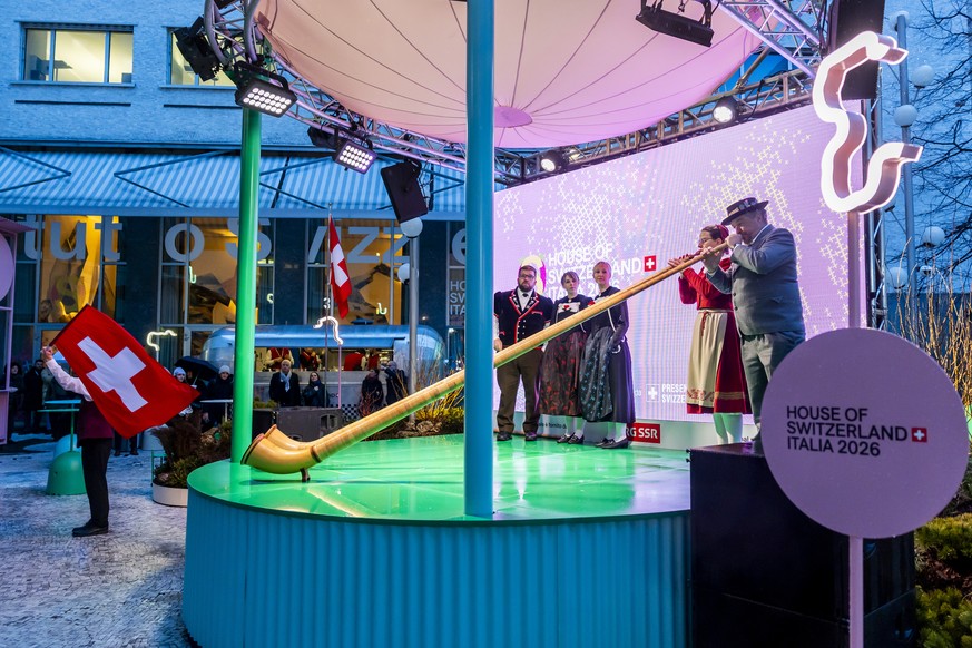 KEYPIX - A flag thrower, Yodelers, and Alphorn players form the Edigenoessischer Jodlerverband perform on the stage during the inauguration of the House of Switzerland, at the 2026 Olympic Winter Game ...