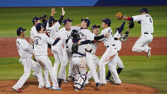 Team Japan celebrate after the gold medal baseball game against the United States at the 2020 Summer Olympics, Saturday, Aug. 7, 2021, in Yokohama, Japan. Japan won 2-0. (AP Photo/Jae C. Hong)