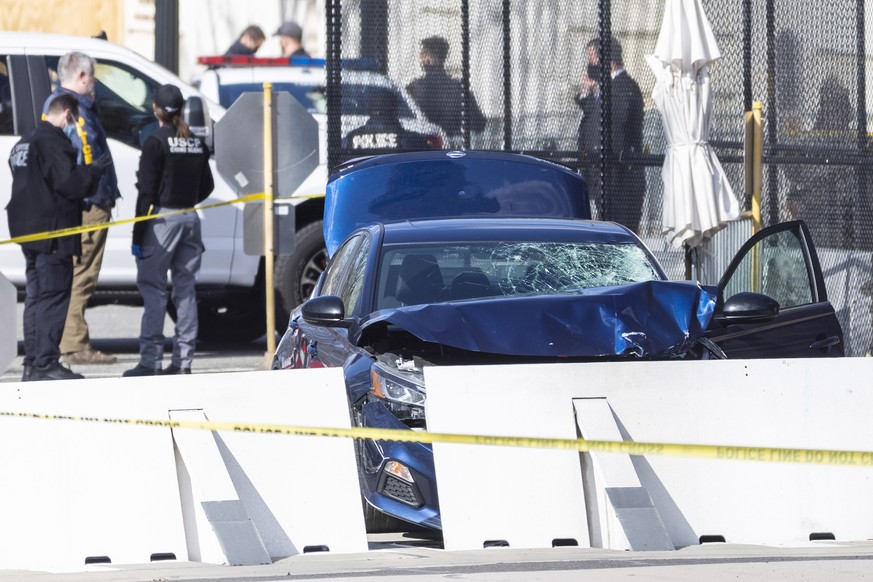 epa09112522 Officials investigate the scene after a vehicle rammed a barricade outside the US Capitol in Washington, DC, USA, 02 April 2021. According to US Capitol Police one police officer was kille ...