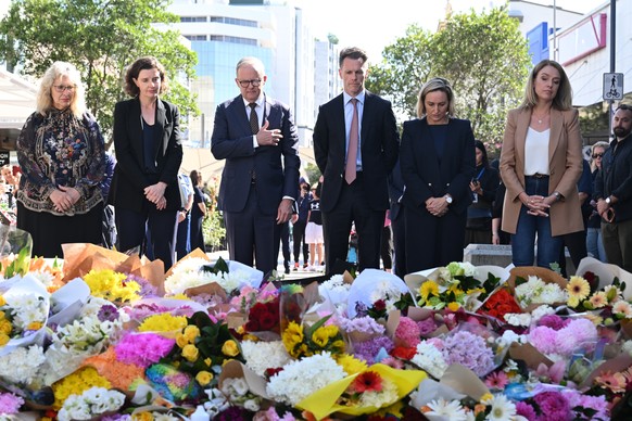 epa11277723 Australian Prime Minister Anthony Albanese (3-L) and NSW Premier Chris Minns (3-R) join other politicians take a moment at the scene of the 13 April stabbing rampage at Bondi Junction in S ...