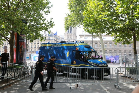 PARIS, FRANCE - JULY 22, 2024: A few days before the beginning of the Paris Olympics, a Paris policeman move a metal barricade to block access to certain areas. (Photo by Owen Franken/Corbis via Getty ...