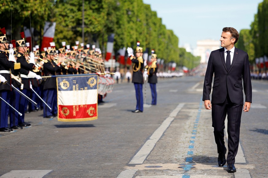 epa10070026 French President Emmanuel Macron reviews the troops during the annual Bastille Day military parade on the Champs-Elysees avenue in Paris, France, 14 July 2022. EPA/SARAH MEYSSONNIER / POOL ...