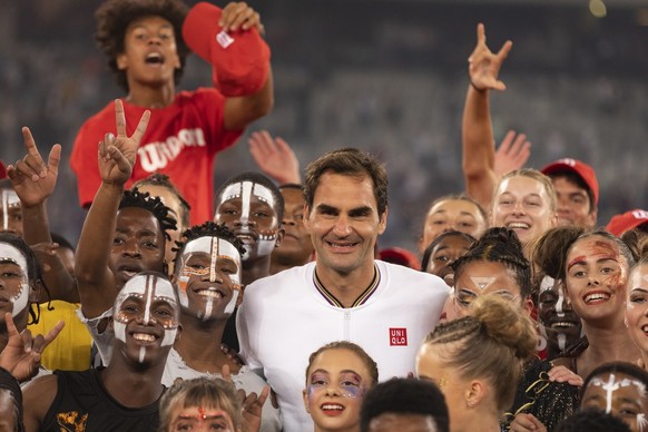 epa08201284 Roger Federer of Switzerland (C) reacts with South African performers after the Match in Africa Cape Town charity event, Cape Town, South Africa 07 February 2020. Presented by Rolex the Ma ...