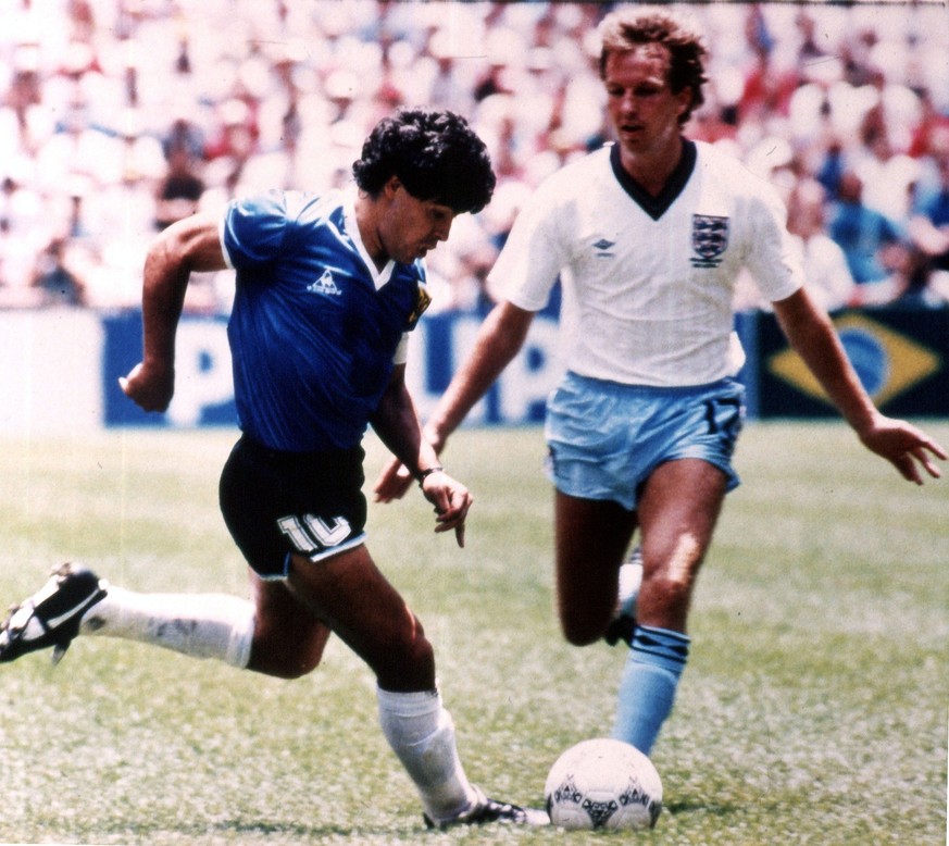 Argentine soccer player Diego Maradona, left, tries to go past England's Trevor Steven, during the World Cup quarter final match, in the Aztec Stadium, Mexico City, on June 22, 1986. (AP Photo)