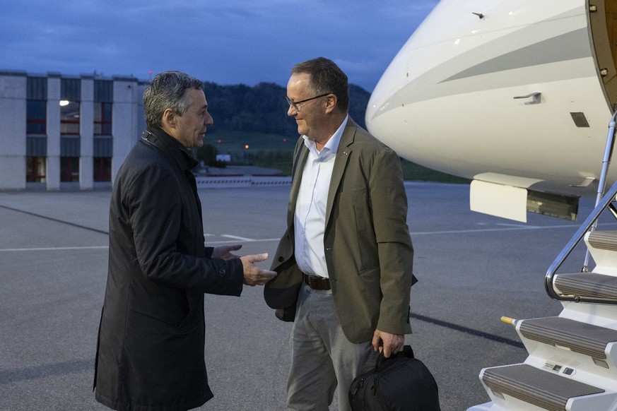 Swiss Federal Councilor Ignazio Cassis, left, welcomes Christian Winter, Swiss Ambassador of Sudan, at the Bern-Belp Airport in Belp, Switzerland, Tuesday, April 25, 2023. Swiss nationals are flown ou ...