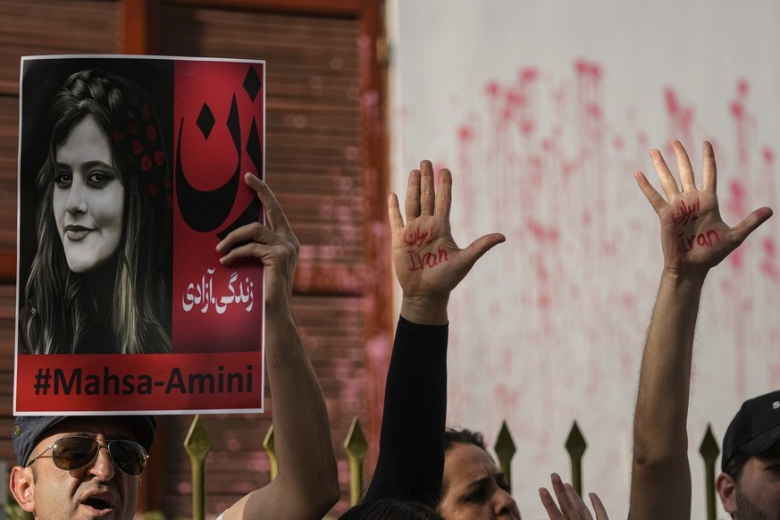 Iranians nationals protest against the death of Iranian Mahsa Amini, in front of the Chilean Human Rights Institute building in Santiago, Chile, Friday, Sept. 30, 2022. The 22-year-old, who died in Ir ...