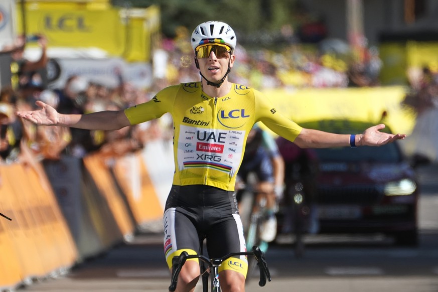 Slovenia's Tadej Pogacar, wearing the overall leader's yellow jersey, crosses the finish line to win the nineteenth stage of the Tour de France cycling race with start in Gap and finish in A ...