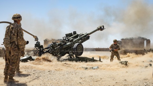epa07832227 A handout photo made available by the US Army shows Soldiers from the 1-118th Field Artillery Regiment of the 48th Infantry Brigade Combat Team firing an M777 Howitzer during a fire missio ...