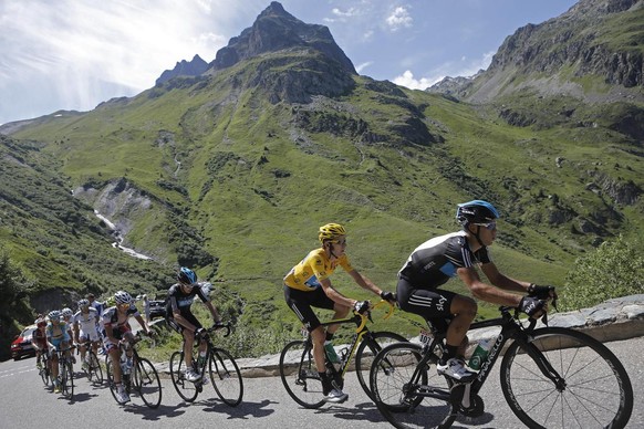 Bradley Wiggins of Britain, wearing the overall leader&#039;s yellow jersey, climbs Croix de Fer pass during the 11th stage of the Tour de France cycling race over 148 kilometers (92 miles) with start ...