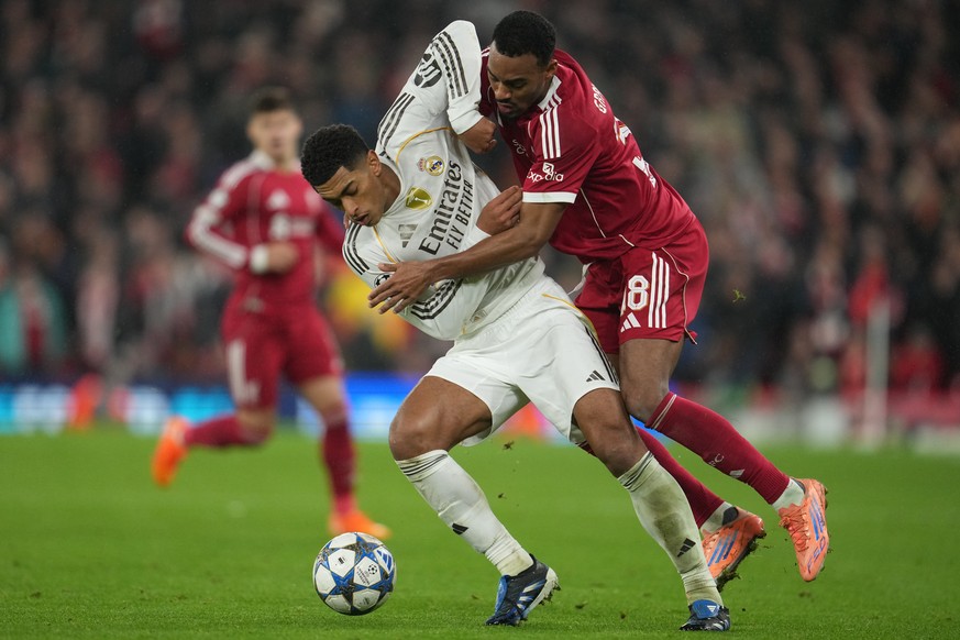 Liverpool's Ryan Gravenberch, right, and Real Madrid's Jude Bellingham fight for the ball during the Champions League soccer match between Liverpool and Real Madrid in Liverpool, England, Tu ...