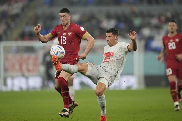 Switzerland&#039;s Fabian Schaer, right, challenges for the ball with Serbia&#039;s Dusan Vlahovic during the World Cup group G soccer match between Serbia and Switzerland, at the Stadium 974 in Doha, ...