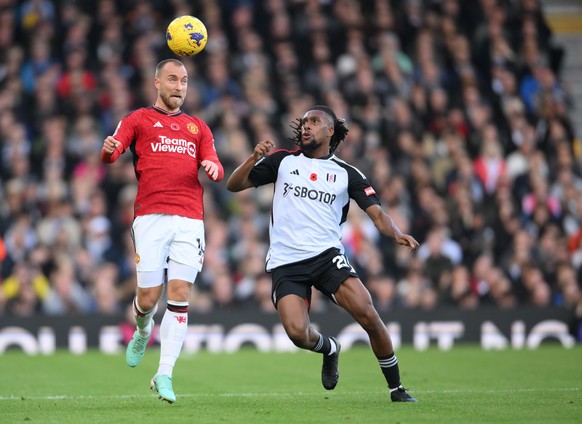 epa10957227 Fulham?s Alex Iwobi (R) and Manchester United&#039;s Christian Eriksen (L) in action during the English Premier League soccer match between Fulham FC and Manchester United, in London, Brit ...