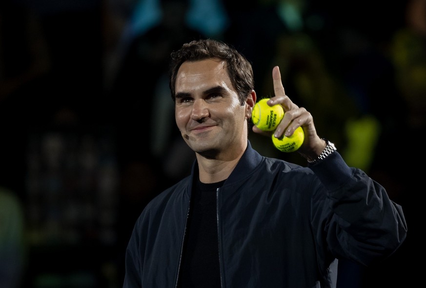 epa10916652 Swiss former tennis player Roger Federer distributes balls with his signature during the Federer&#039;s Fan Day at the Shanghai Masters tennis tournament, Shanghai, China, 13 October 2023. ...