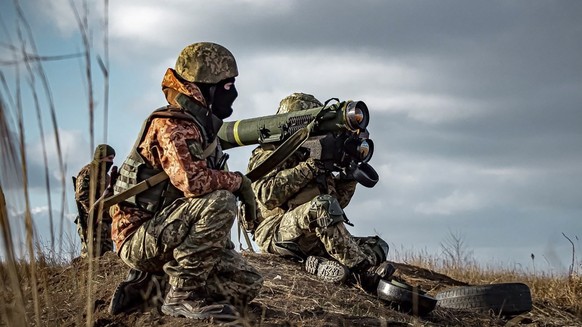 In this image released by Ukrainian Defense Ministry Press Service, Ukrainian soldiers use a launcher with US Javelin missiles during military exercises in Donetsk region, Ukraine, Thursday, Dec. 23,  ...