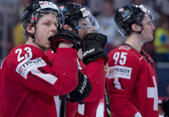 Team Switzerland Simon Bodenmann, left, reacts to his team&amp;#039;s loss to Sweden in the gold medal game Sunday, May 19, 2013 at the world hockey championship in Stockholm, Sweden. (AP Photo/The Ca ...