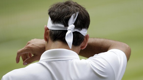 Switzerland&#039;s Roger Federer wipes his face during the men&#039;s singles final match against Serbia&#039;s Novak Djokovic at the Wimbledon Tennis Championships in London, Sunday, July 14, 2019. ( ...