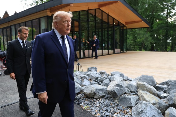 epa13042214 US President Donald Trump (R) arrives with France's President Emmanuel Macron prior to a group photograph at the G7 summit in Evian-les-Bains, central-eastern France, 16 June 2026. Th ...