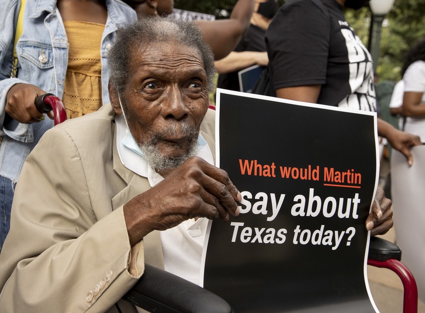 Un Texan brandit une affiche sur laquelle est inscrit: «que dirait Martin (Luther King) sur le Texas aujourd'hui?»