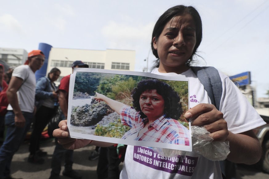 epa11411082 A member of the Civic Council of Popular and Indigenous Organizations of Honduras (Copinh), holds a portrait of Honduran environmentalist Berta Caceres during a demonstration in front of t ...