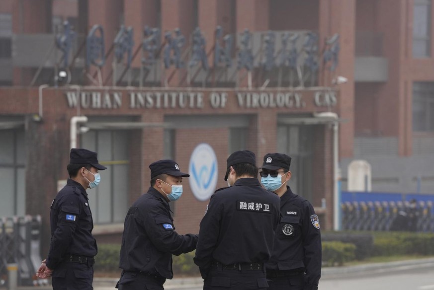 Security personnel gather near the entrance of the Wuhan Institute of Virology during a visit by the World Health Organization team in Wuhan in China&#039;s Hubei province on Wednesday, Feb. 3, 2021.  ...