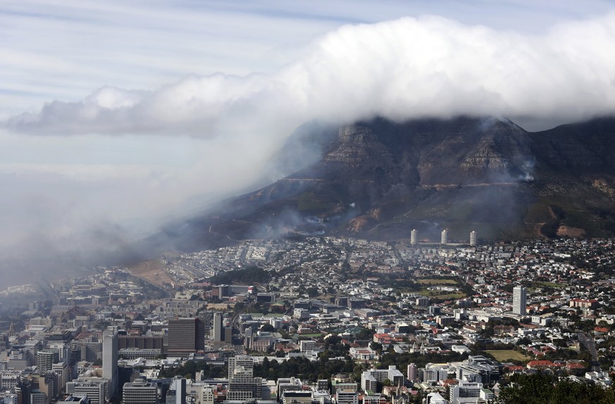 Clouds of smoke are seen above the city of Cape Town, South Africa, Monday, April 19, 2021. Residents are being evacuated from Cape Town neighborhoods after a huge fire spreading on the slopes of the ...