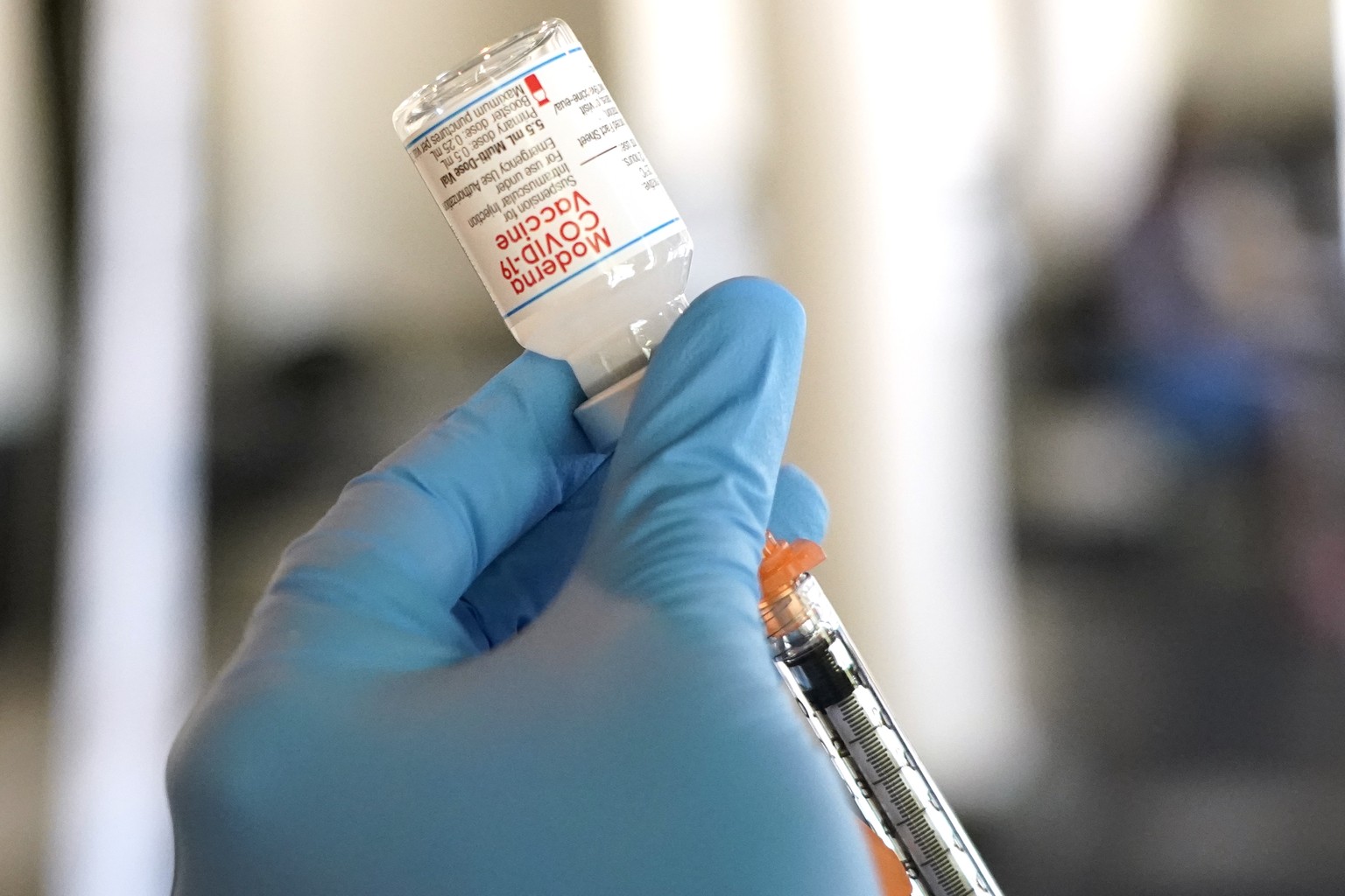 A Jackson-Hinds Comprehensive Health Center nurse loads a syringe with the Moderna COVID-19 vaccine at an inoculation station next to Jackson State University in Jackson, Miss., Tuesday, July 19, 2022 ...