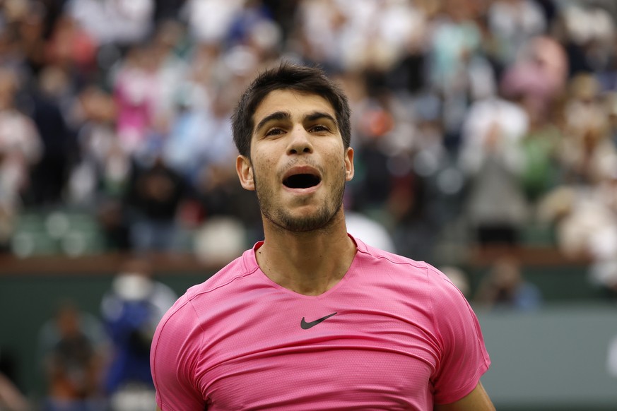 epa10533169 Carlos Alcaraz of Spain reacts after winning match point against Daniil Medvedev of Russia during the men&#039;s finals of the BNP Paribas Open tennis tournament at the Indian Wells Tennis ...