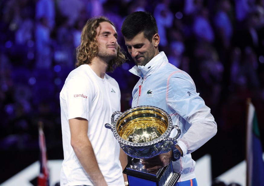 epa10438217 Winner Novak Djokovic (L) of Serbia and runner up Stefanos Tsitsipas of Greece hold their trophies after the Men&#039;s Singles final at the Australian Open tennis tournament in Melbourne, ...