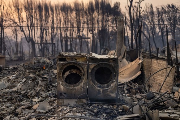 PACIFIC PALISADES, CALIFORNIA - JANUARY 08: The charred remains of a washer and dryer, on a property destroyed in the Palisades Fire, on January 8, 2025 in the Pacific Palisades community of Los Angel ...
