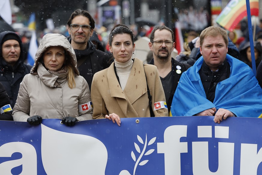 epa09865549 Ukrainian politicians Olena Khomenko and Maria Mezentseva, and Artem Rybchenko, Ukrainian ambassador to Switzerland, from left, take part in a national demonstration against the Russian in ...