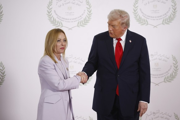 epa12451500 Italian's Prime Minister Giorgia Meloni (L) and and US President Donald Trump shake hands during the greetings ceremony before the family picture at the Gaza Peace Summit in Sharm El- ...
