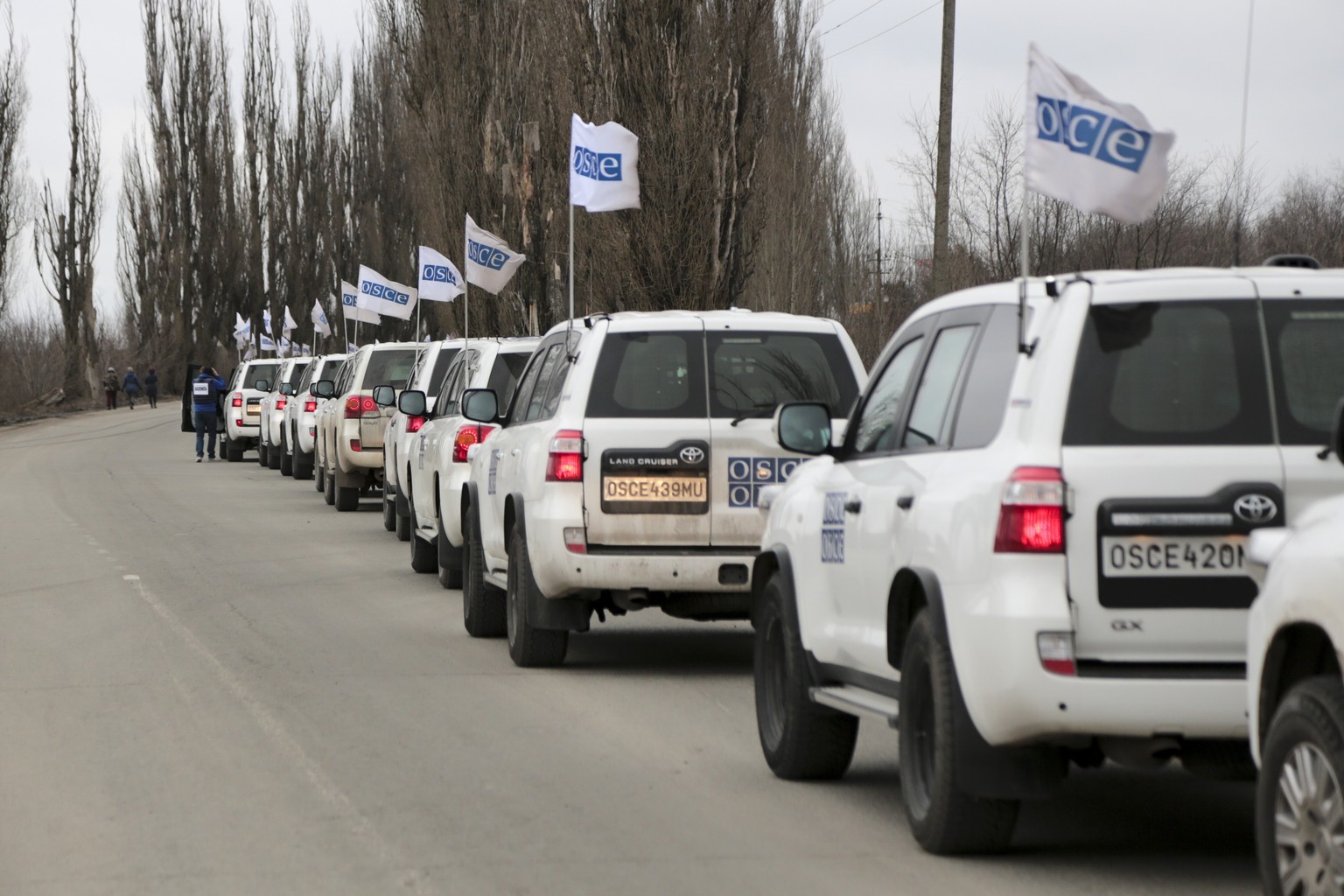 Column of vehicles of the OSCE mission lineup to leave Donetsk People Republic, the territory controlled by pro-Russian militants, near the Uspenka checkpoint toward Ukrainian-Russia border, eastern U ...