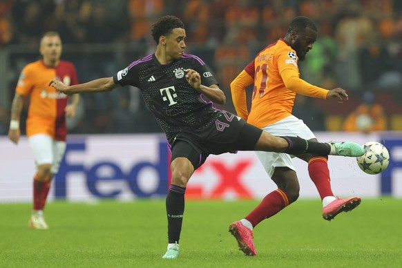 Bayern&#039;s Jamal Musiala, left, and Galatasaray&#039;s Tanguy Ndombele vie for the ball during a Champions League group A soccer match between Galatasaray and Bayern Munich in Istanbul, Tuesday, Oc ...