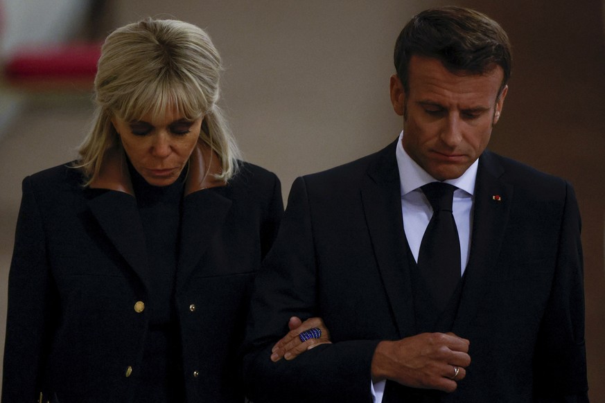 France&#039;s President Emmanuel Macron and first lady Brigitte Macron pay their respects to the coffin of Britain&#039;s Queen Elizabeth, following her death, during her lying-in-state at Westminster ...