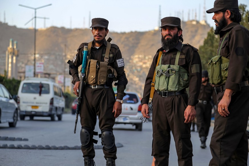 epa11602670 Afghans Taliban security officials stand guard as they check people and vehicles at a checkpoint, in Kabul, Afghanistan, 13 September 2024. Gunmen killed 14 people and injured six others i ...