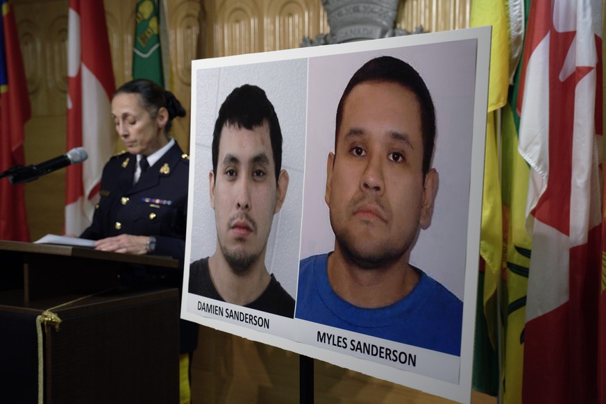 Assistant Commissioner Rhonda Blackmore speaks next to images of Damien Sanderson and Myles Sanderson during a press conference at the Royal Canadian Mounted Police &quot;F&quot; Division headquarters ...