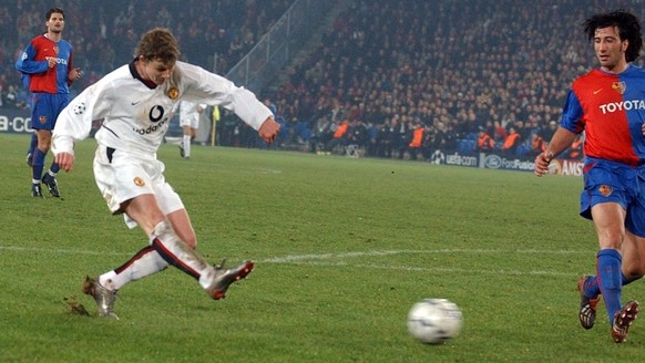 Manchester&#039;s Ole Gunnar Solskjaer, left, scores Manchester&#039;s third goal against Murat Yakin of Basel, right, during the UEFA Champions League soccer match between FC Basel and Manchester Uni ...