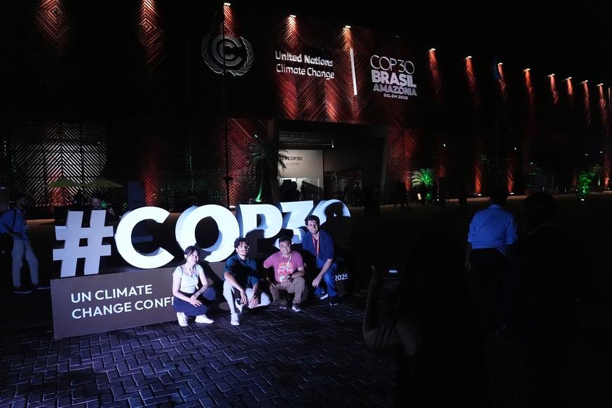 People pose for photos outside the venue for the COP30 U.N. Climate Summit, Friday, Nov. 21, 2025, in Belem, Brazil. (AP Photo/Joshua A. Bickel)
Climate COP30