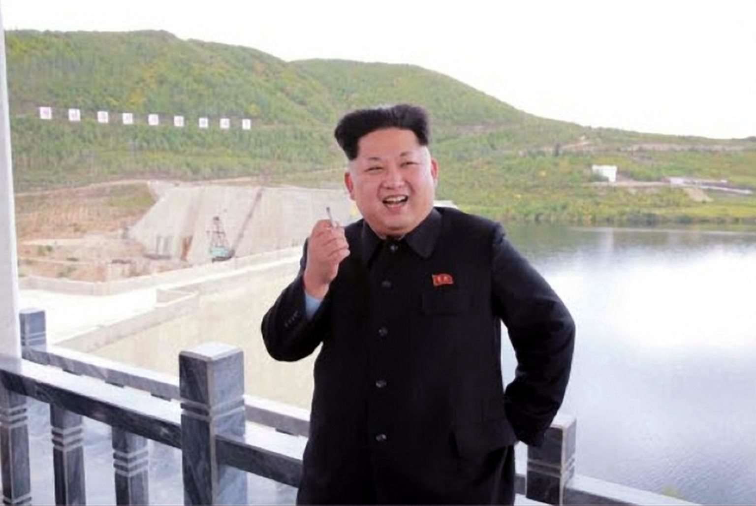 epa04929495 An undated picture released by the Rodong Sinmun, the newspaper of the North Korea ruling Workers Party, on 14 September 2014 shows North Korean leader Kim Jong-un smiling with a cigarette ...