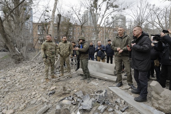 epa11242701 Mayor of Kyiv Vitali Klitschko inspects (2R) the site of a damaged building after a rocket strike in Kyiv, Ukraine, 25 March 2024, amid the Russian invasion. A three-story building housing ...