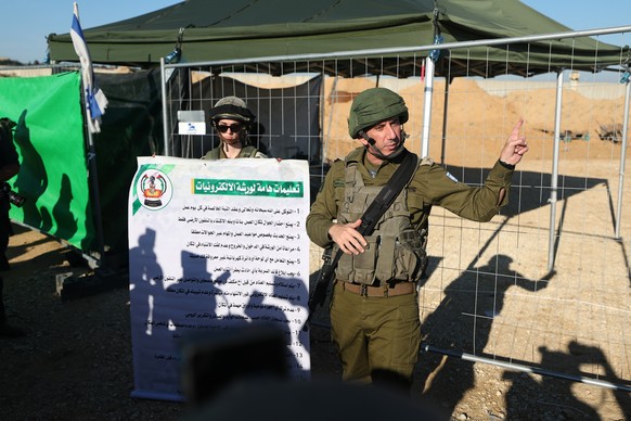 epa11034231 A photo taken while embedded with the Israeli Army shows Israeli Rear Admiral Daniel Hagari (R) next to the entrance of a tunnel 400 meters away from the Erez crossing between Gaza and Isr ...