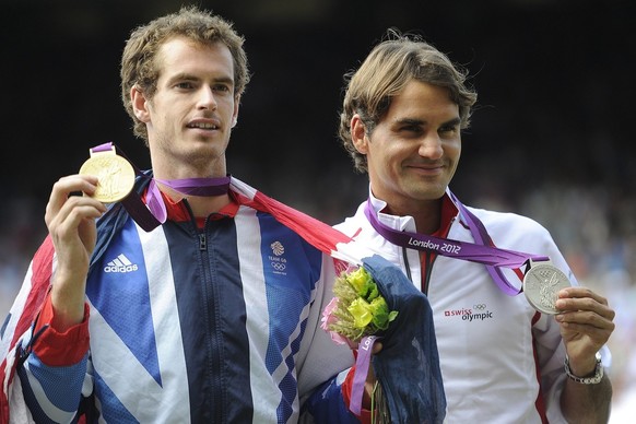 Switzerland&#039;s Roger Federer, right, reacts with the silver medal next to winner Britain&#039;s Andy Murray, left, during the medals ceremony after the men&#039;s singles gold medal match against  ...